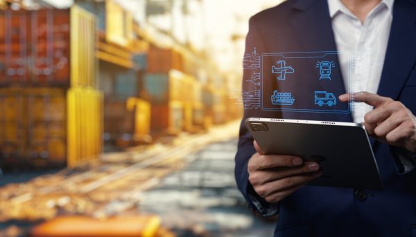 A Business Professional Uses A Tablet To Enhance Logistics Management